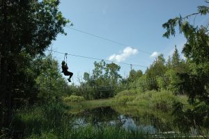 ziplining over a pond in door county