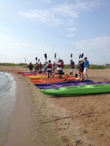 group of kayak tour in door county on beach